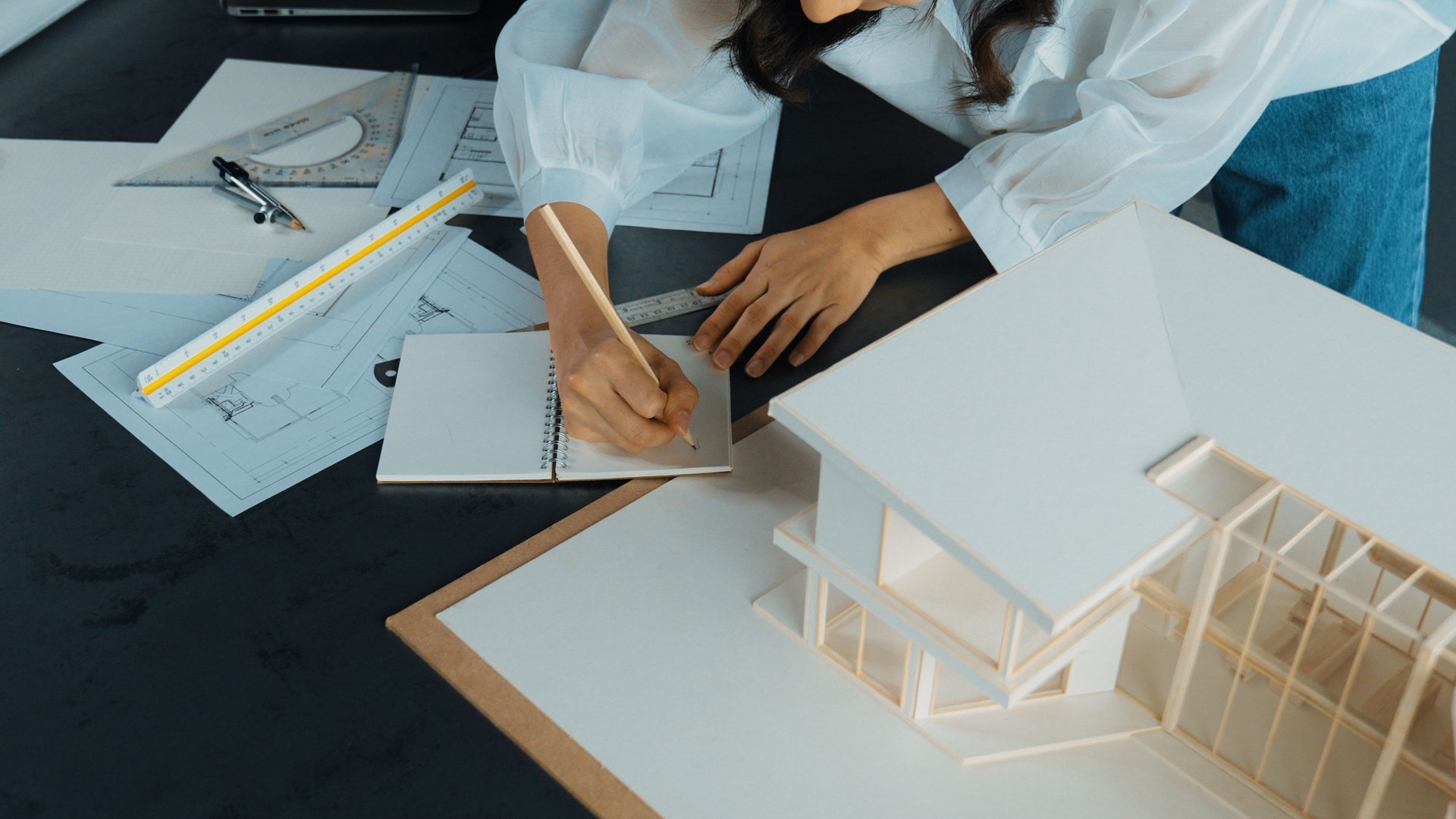 Top view of architect hands taking note about house construction. Manipulator.